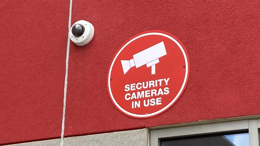 security camera: Vandal dome-style security camera next to signage on exterior of Target store