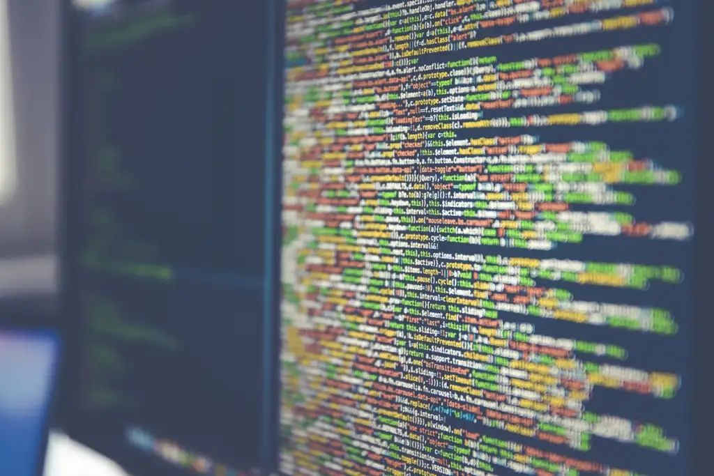 vibe coding: Code on computer monitor (Unsplash)