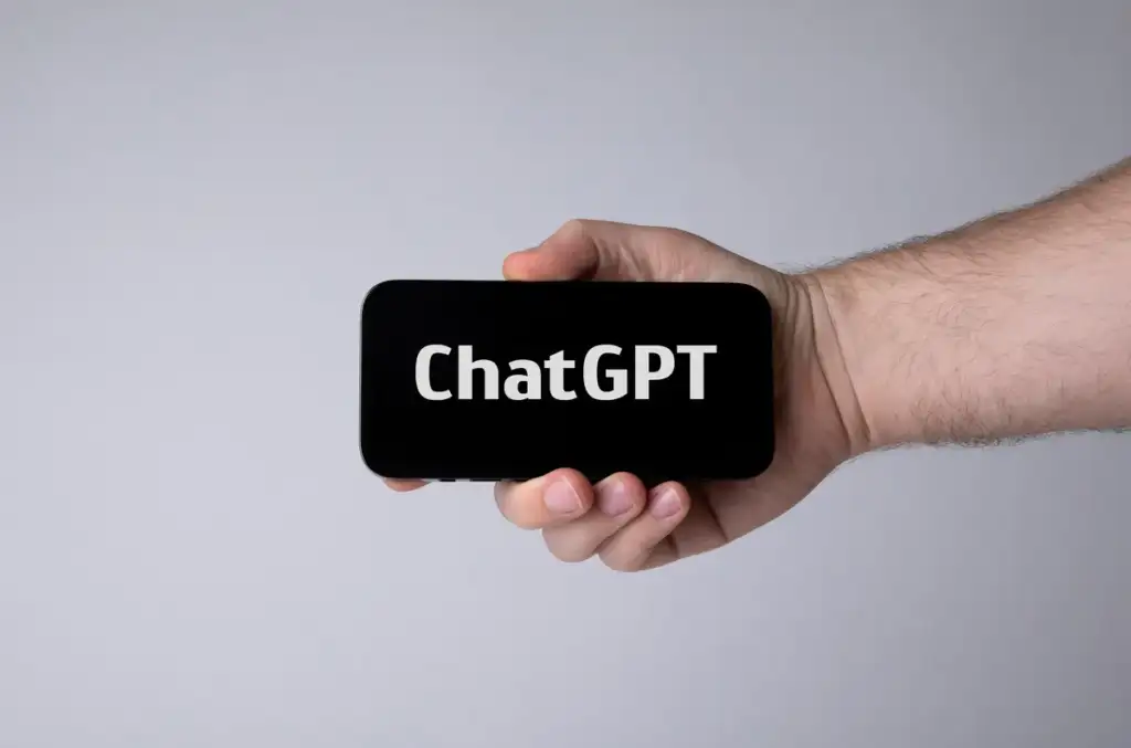 ChatGPT Dots in Slack: Hand holding smartphone with ChatGPT (52917076309)