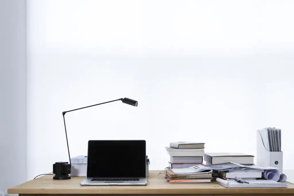MacBook Pro M6 price: Laptop on desk book stacks (Unsplash)